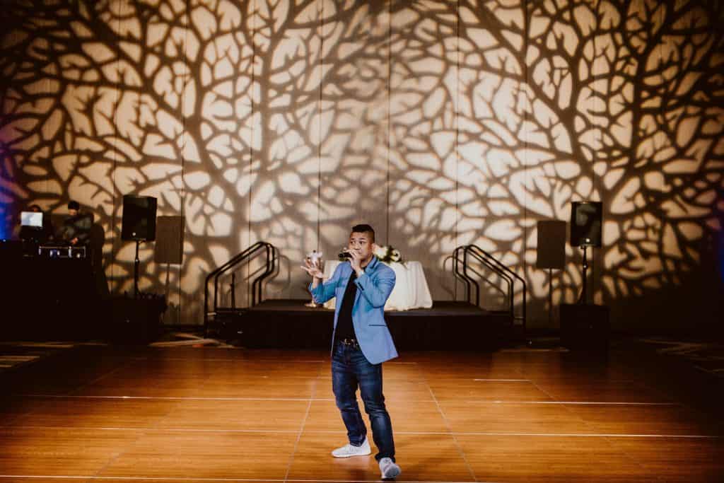 DJ Buddy on the mic as MC at a wedding reception