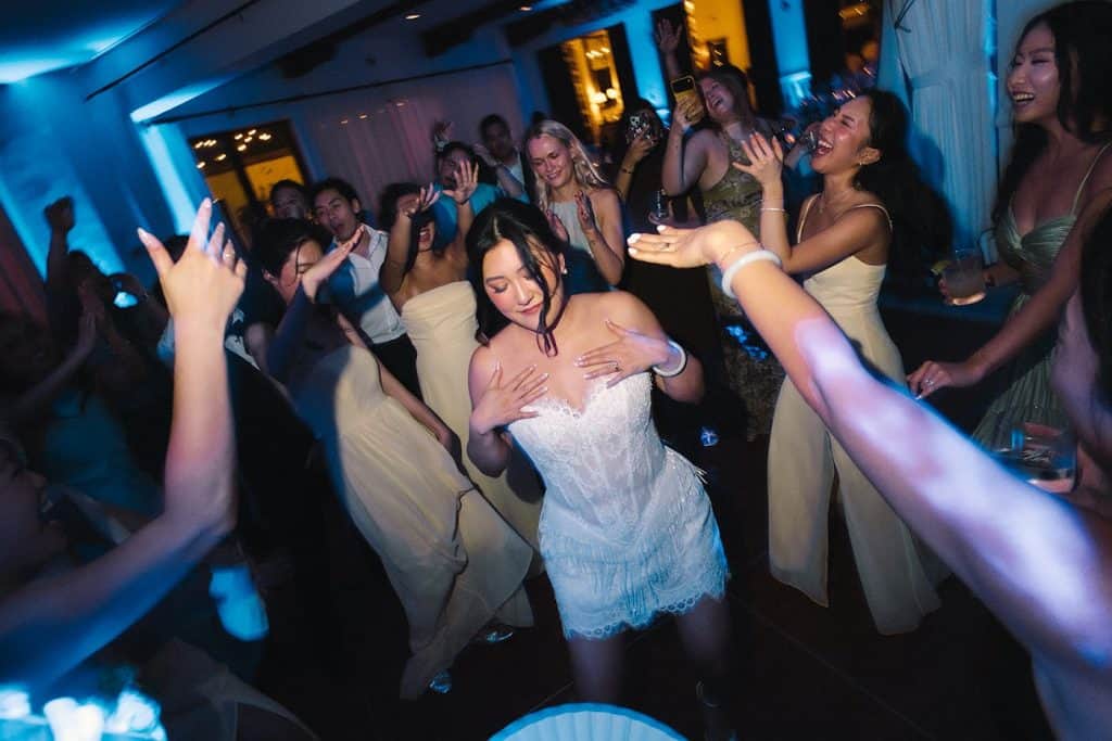 Bride dancing, blue light, packed floor, Kristine & Patrick wedding at Bel-Air Bay Club
