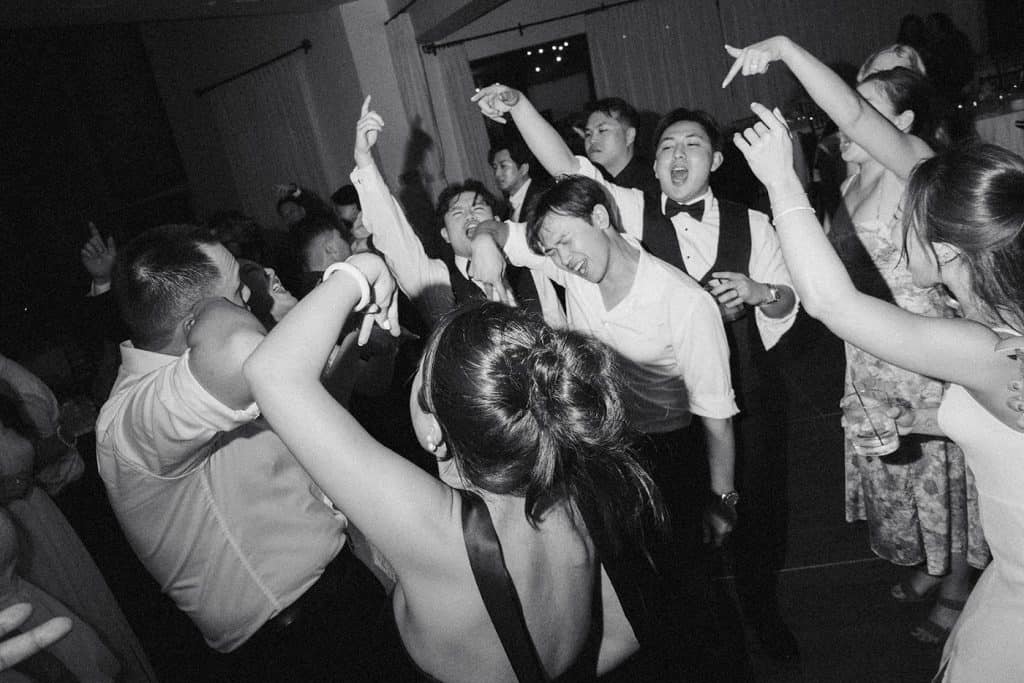Black-and-white hands-up crowd, Kristine & Patrick wedding at Bel-Air Bay Club