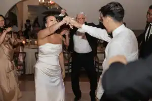 Rachel and Aaron dancing with guests at their Grand Gimeno reception, Orange