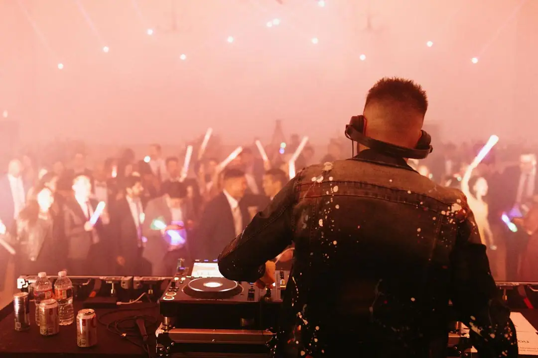 Gareth Emery playing to guests with light sticks at Grand Gimeno, Orange