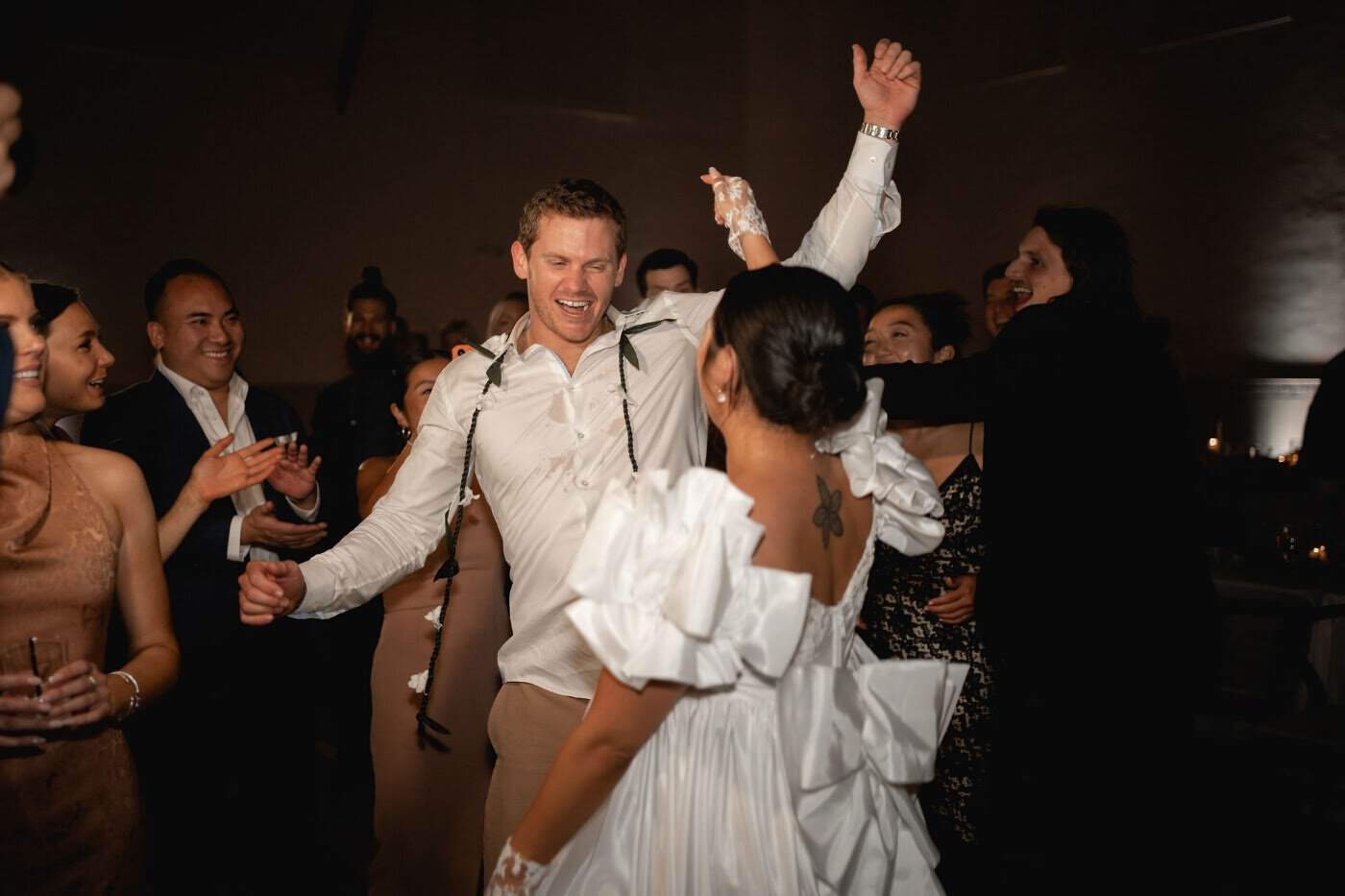 Couple dancing with guests cheering during the reception at Grand Gimeno