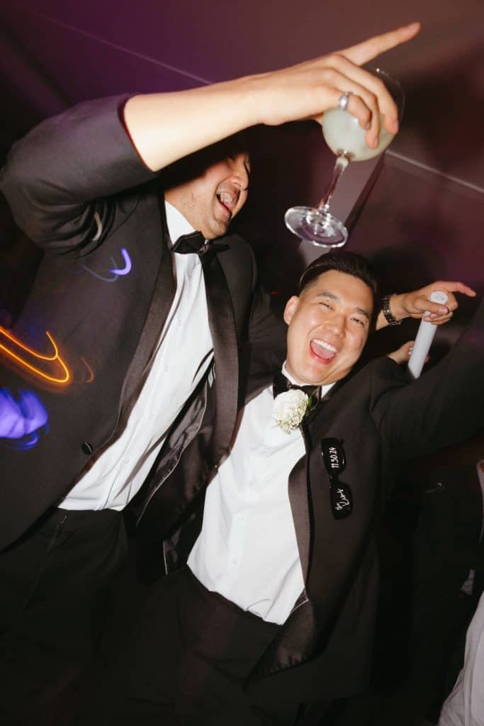Groom mid-air and hype, flash, Abbey & Edward wedding at The Harper, Costa Mesa
