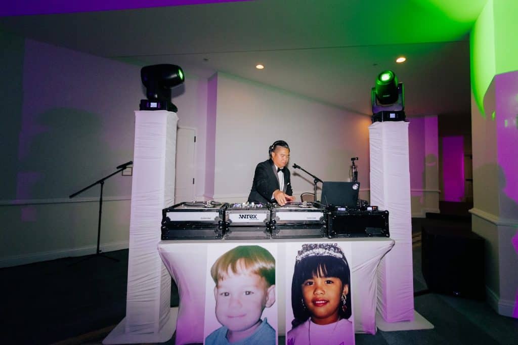 DJ Wrex at white booth, moving heads, custom kid-photo facade, Julia & Tim wedding at Hotel del Coronado