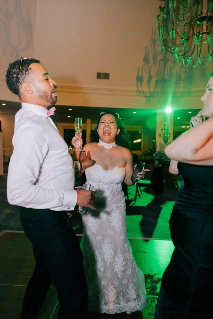 Couple partying, green lighting, Julia & Tim wedding at Hotel del Coronado