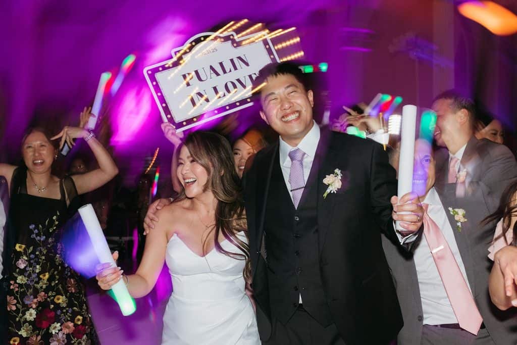 Couple with signs, purple wash, Charisse & Fred wedding at Vibiana
