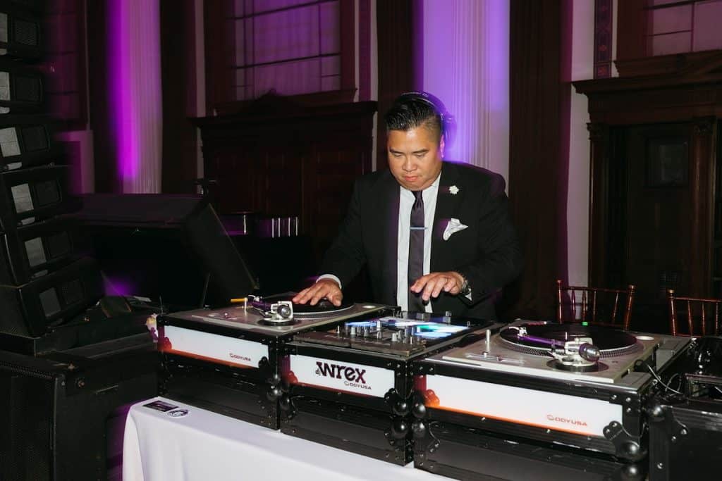 DJ Wrex at booth with purple uplights, Charisse & Fred wedding at Vibiana