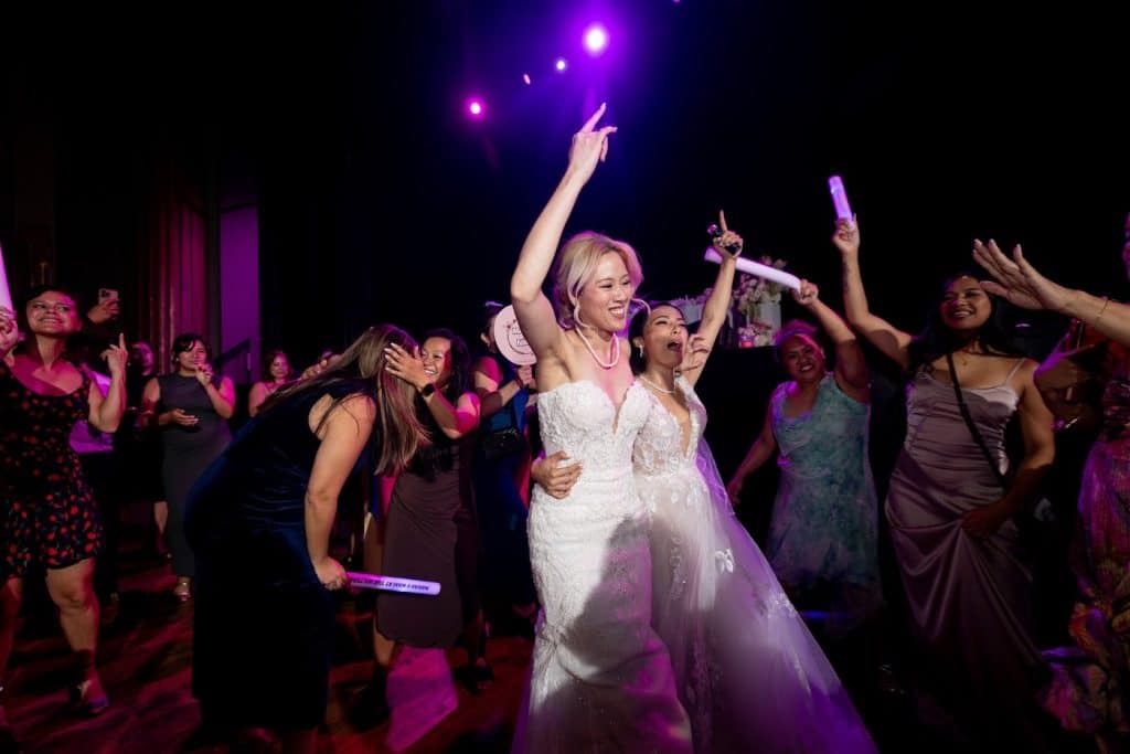 Couple dancing, purple light, cheering crowd, Mariah & Nikki wedding at The Wiltern